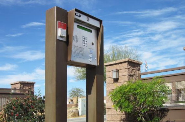 Doorking telephone entry system on the pol, in front of the entrance to gated residential community.