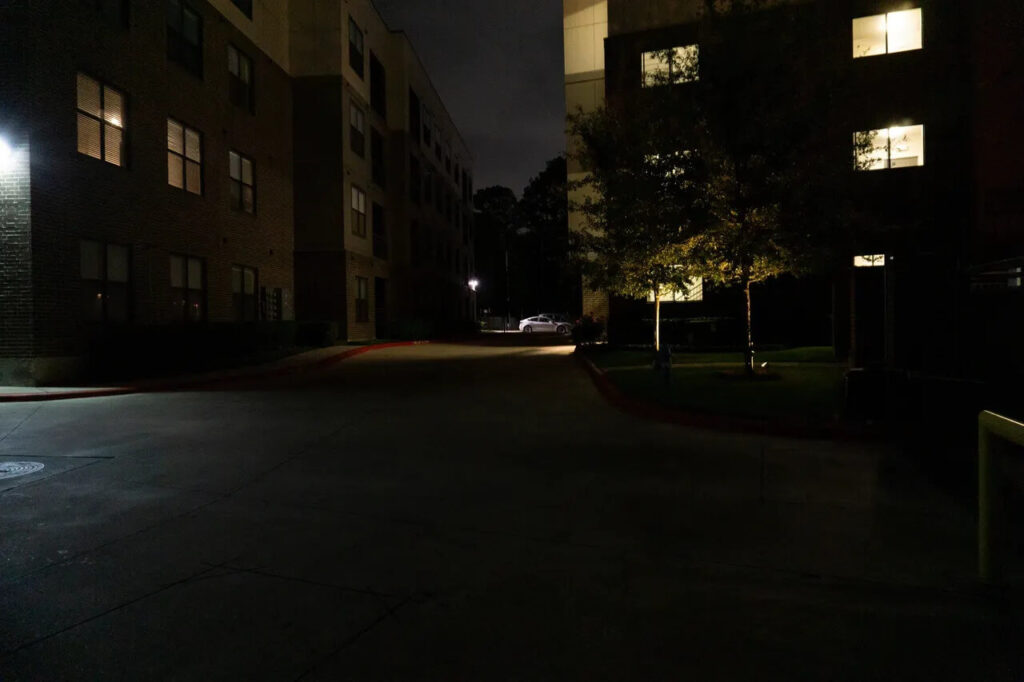Dark and unsafe entrance of a MUDs complex, emphasizing the importance of property management LED lighting.