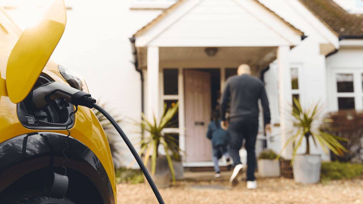 Family at home with electric vehicle using Level 1 charging, relevant to our EV Charging Guide.