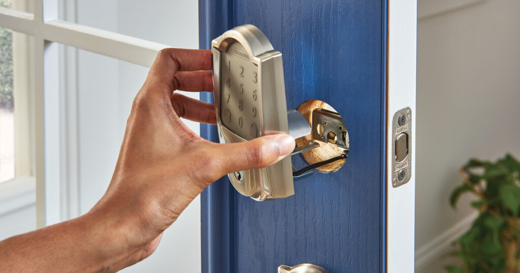 Man installing Schlage Smart Door Lock close-up.