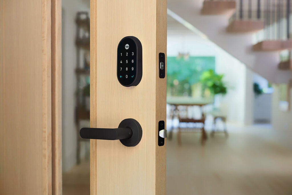 Yale Smart Lock on half-opened apartment door with interior view.